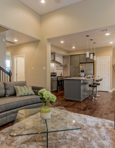 Modern open-plan living space with kitchen, dining area, and living room.